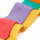 Frugi GOTS 100% organic cotton 2 pack tights in yellow and a pastel rainbow striped design laid on top of eachother