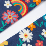 Pair of Frugi kids norah tights showing a close up of the playful floral design on  on navy organic cotton fabric