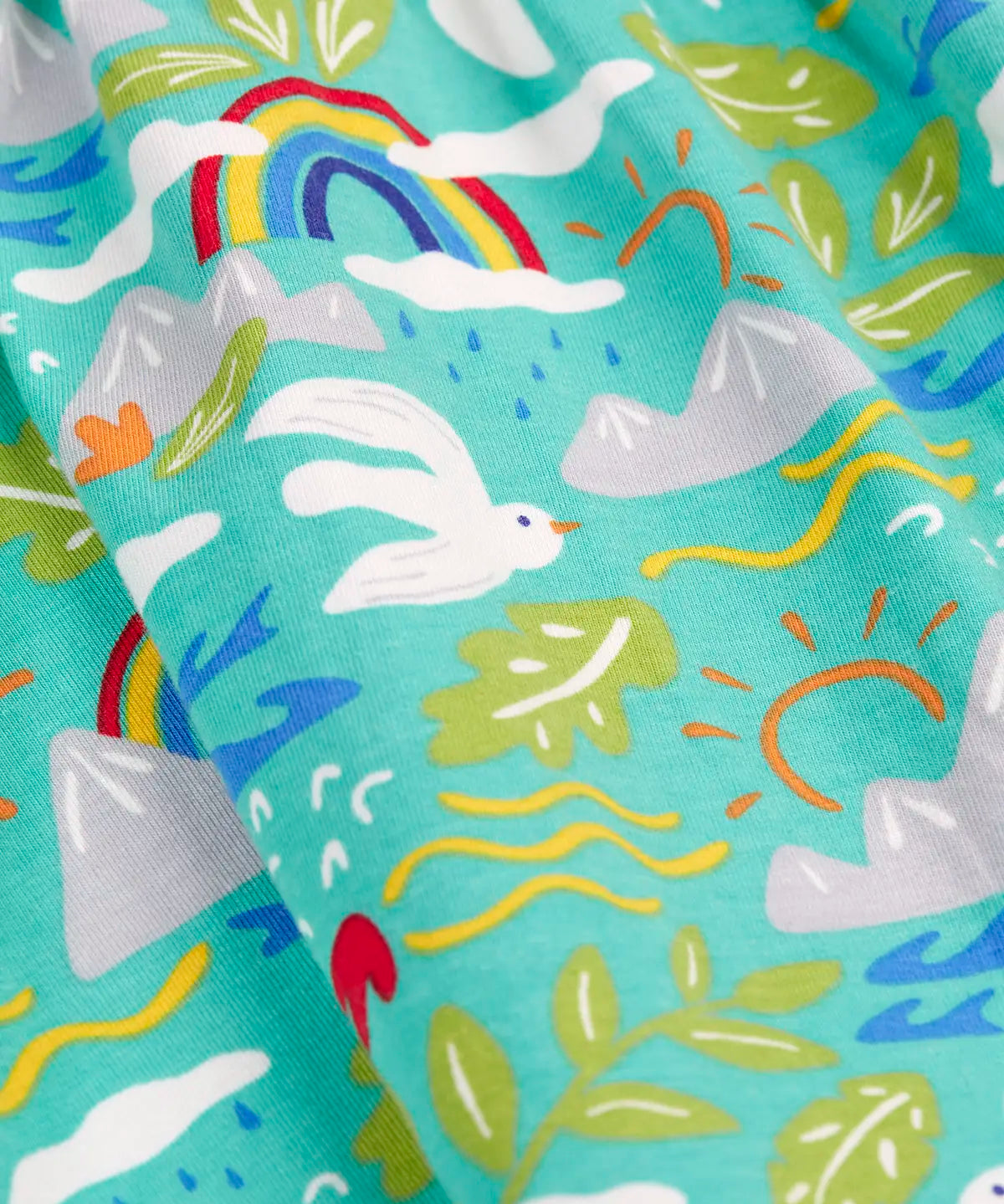 Frugi skater dress in aqua laid flat showing repeating seagull and mountain design