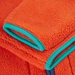 A closer look at the sleeves on the Frugi Toby Ted Fleece Jacket - Bonfire, showing the light blue piping