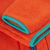 A closer look at the sleeves on the Frugi Toby Ted Fleece Jacket - Bonfire, showing the light blue piping