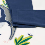 A closer look at the navy blue sleeves on the Frugi Alfie Raglan Top - Navy Blue/Anteater, with the anteater applique showing partially underneath