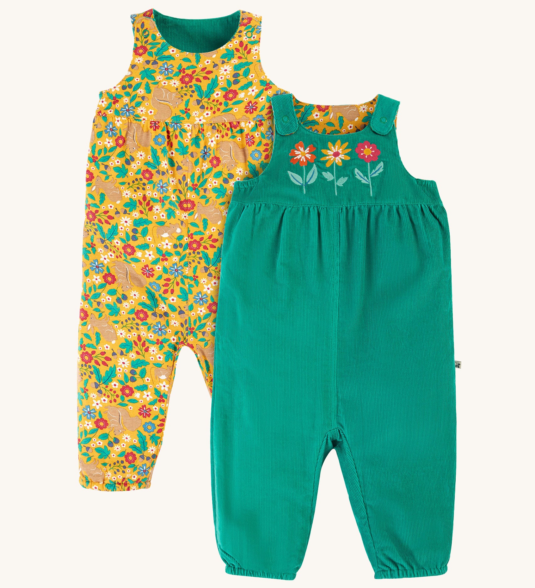 Frugi Lacey Reversible Dungaree - Iguana/Autumn Friends. One side is green with 3 flower appliques, and the other is a yellow floral and rabbit print