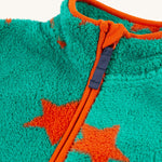 A closer look at the zipper on the Frugi Zipped Ted Fleece Jacket - Bonfire Stars, emphaising the orange piping and orange stars on the green fleece