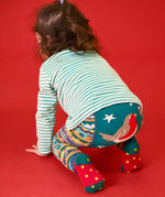 Child crawling away wearing the Frugi GOTS organic knitted footless leggings with a festive fair isle design with large robin on the back.