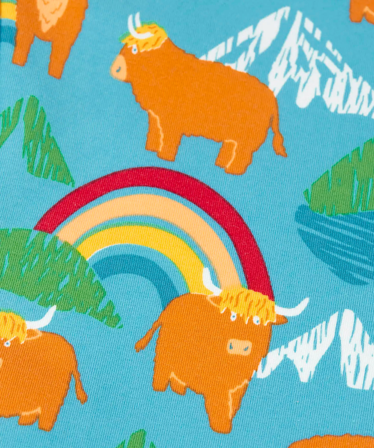 Frugi libby leggings showing a close of the repeating highland cow and mountain print on light blue organic cotton fabric