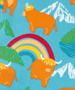 Frugi libby leggings showing a close of the repeating highland cow and mountain print on light blue organic cotton fabric