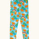 Frugi GOTS 100% organic cotton libby leggings in light blue with a repeating highland cow and mountain print. Features an elasticated waist band for easy wear