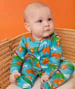 Frugi babygrow in blue Highland cow print from the lovely baby gift set worn by baby.