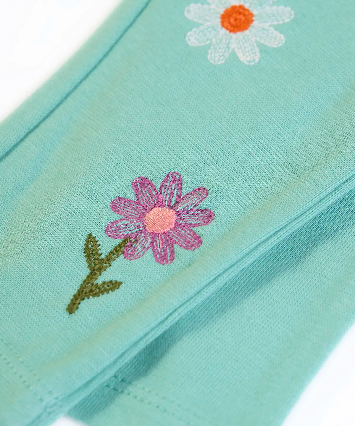 Frugi GOTS organic cotton mabel outfit showing a close up of the flower ebroidery on the moss green trousers 