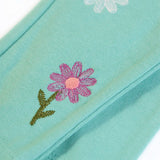 Frugi GOTS organic cotton mabel outfit showing a close up of the flower ebroidery on the moss green trousers 