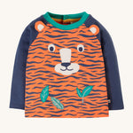 Frugi Happy Raglan Top - Tiger, with navy arms an orange and navy tiger stripe body and a fun tiger face and leaf applique on the front