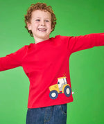 Frugi organic cotton Scout top in red with yellow tractor applique near hem, worn by boy.