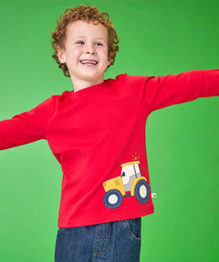 Frugi organic cotton Scout top in red with yellow tractor applique near hem, worn by boy.