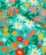 Frugi GOTS 100% organic cotton snuggle joggers in light green with a floral design showing close up of padded kneepatch