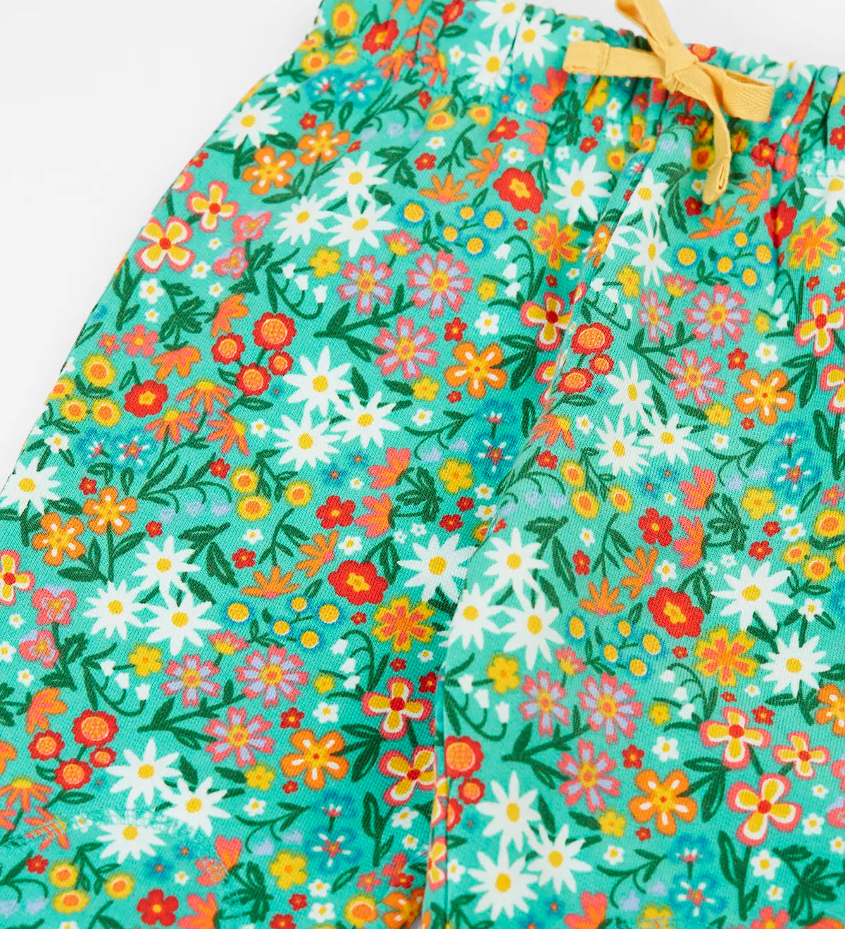 Frugi GOTS 100% organic cotton snuggle joggers in light green with a floral design and a elasticated waistband with drawcord