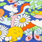 A closer look at the Frugi Retro Happy print. The image shows colourful smiling flowers and planets, stars, clouds, a bee and a butterfly on a royal blue fabric