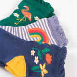 Frugi Freya Frilled Socks 3 Pack - Rainforest Friends. Organic Cotton frill socks in lovely 'Rainforest Friends' designs, one pair comes in navy with delicate flowers and yellow heels and toes, one green pair features a flamingo with lilac heels and cuffs, and the other comes in a lilac stripe with a rainbow on the ankles