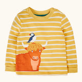 Frugi GOTS 100% organic cotton kids long sleeve top in yellow and white stripes with a highland cow and puffin applique on the bottom
