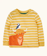 Frugi GOTS 100% organic cotton kids long sleeve top in yellow and white stripes with a highland cow and puffin applique on the bottom