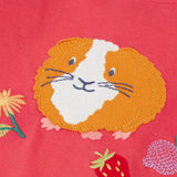 Frugi kids long sleeve top showing a close up of the playful guinea pig applique on pink organic cotton fabric