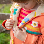 A child looking down at the flower pop fleece inside the jacket