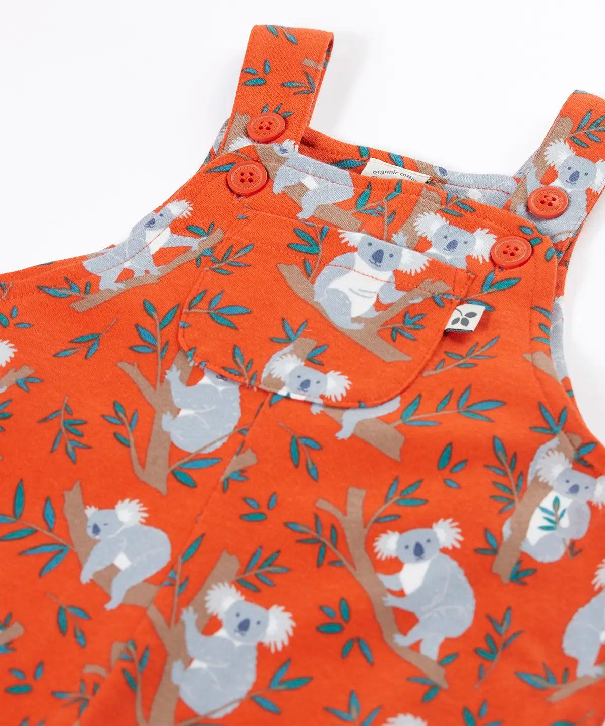 Frugi kids parsnip dungarees in salamander orange with repeating koala prints showing the adjustable shoulder straps and pocket pocket