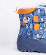 A close up of the Frugi out and about snow boots in penguin waddle showing the orange trim and penguin print detail.