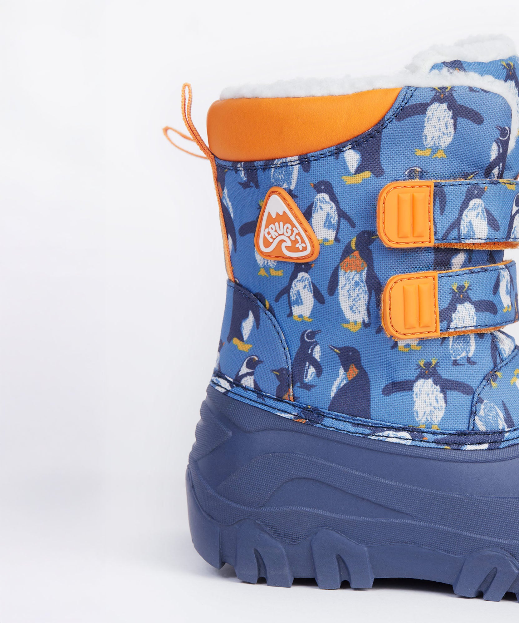 A close up of the Frugi out and about snow boots in penguin waddle showing the orange trim and penguin print detail.