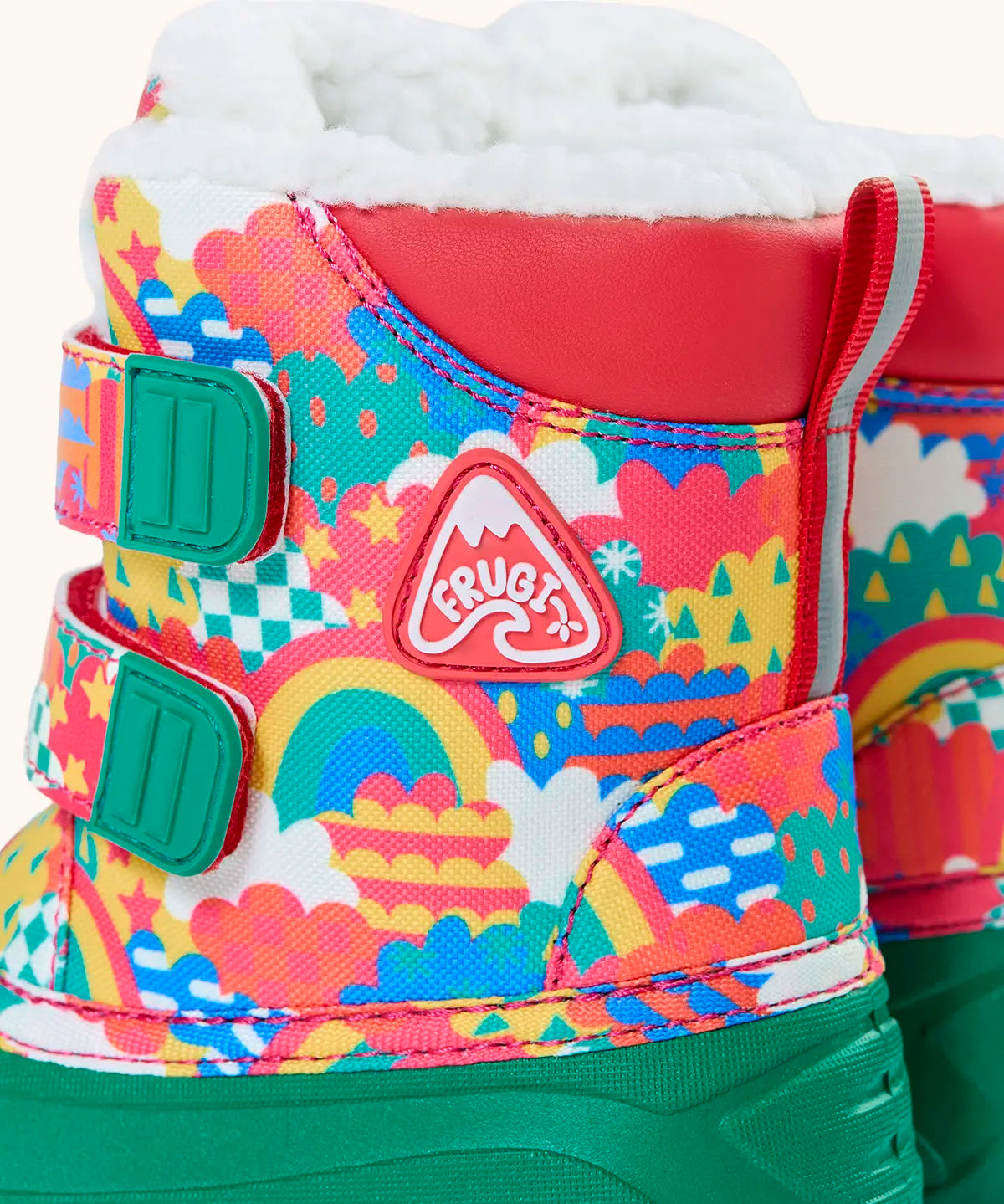 Side of Frugi out and about snow boots in fun frenzy showing a repeating bright pattern design, velcro fasteners and ankle padding 