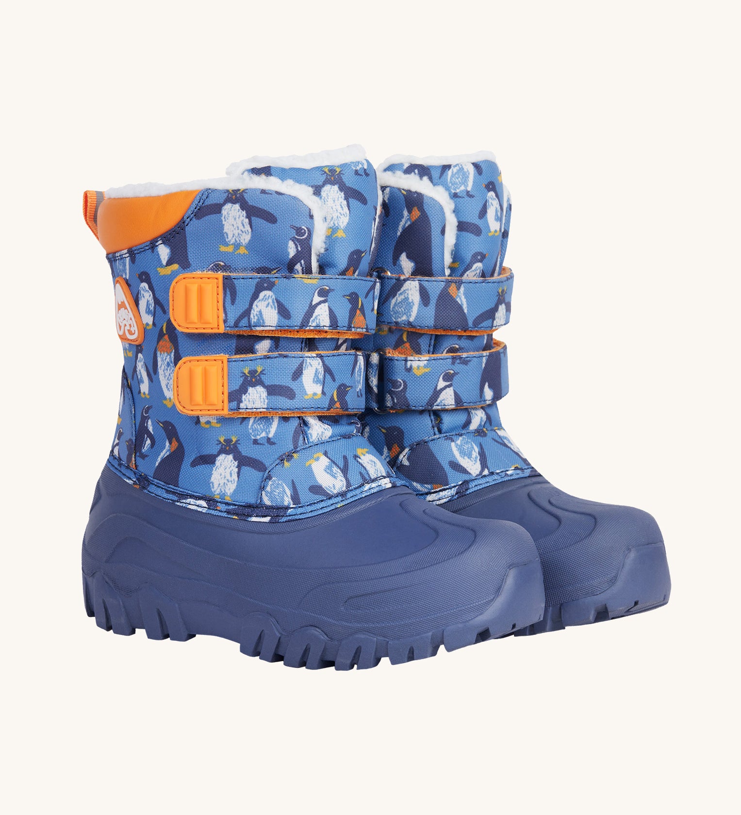 Frugi out and about snow boots in penguin waddle available at Babipur. A blue winters boot with orange trim and a penguin print. Features a fleece inner and velcro fasteners. 