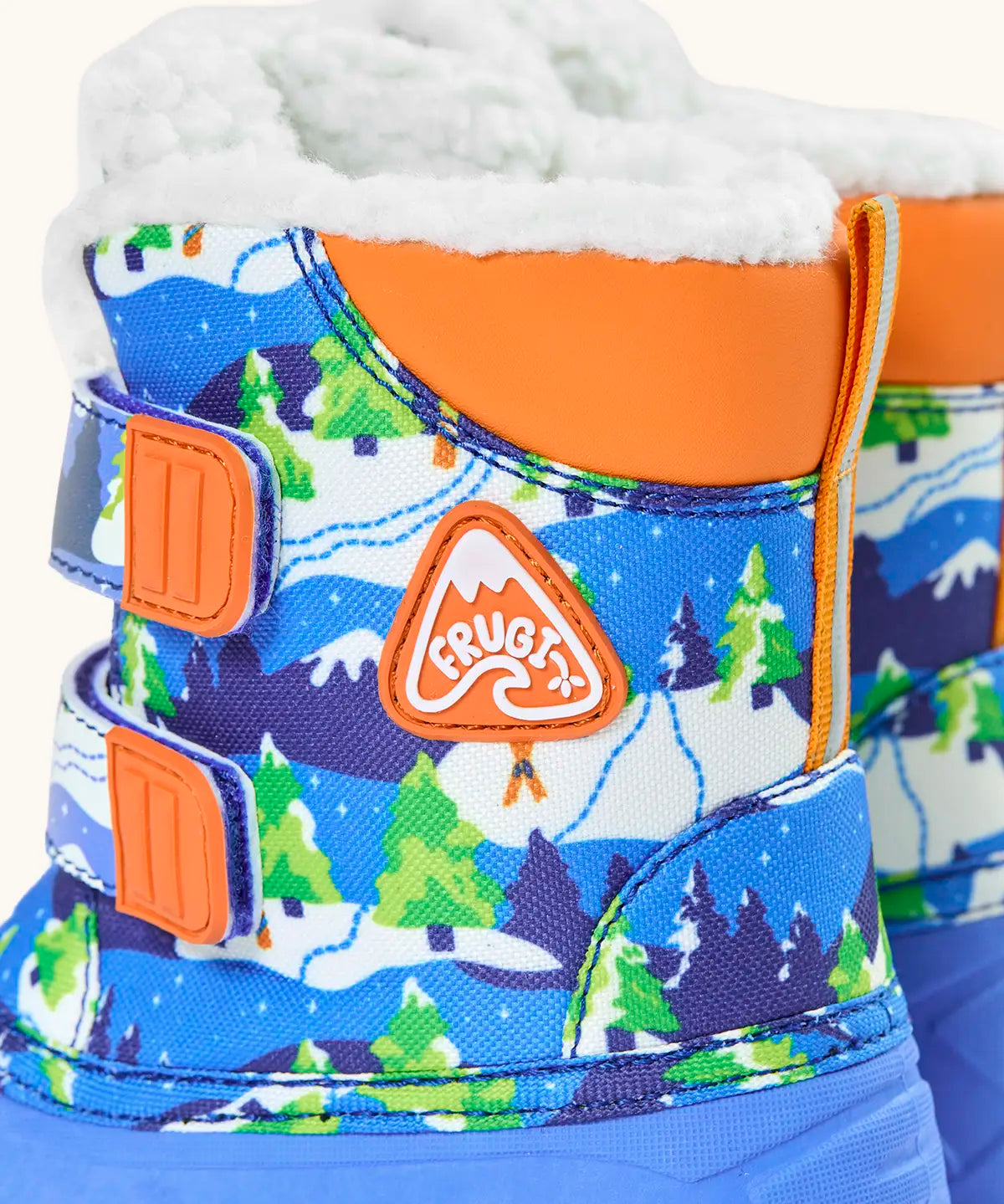 Side of  Frugi out and about snow boots in starry slopes showing the winter showing orange ankle padding and fleece inner lining