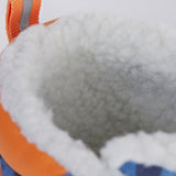 A close up of the Frugi out and about snow boots in penguin waddle showing the white fleece inner detail