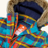 Frugi's Penhale parka coat in a blue red and yellow tartan check laid flat showing fur trim on the hood and navy fleece inner liner