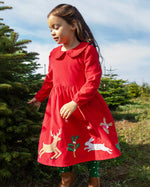 Child wearing Frugi Peony Corduroy Dress Red Robin - a Christmas party dress made from GOTS organic cotton - available at Babipur.
