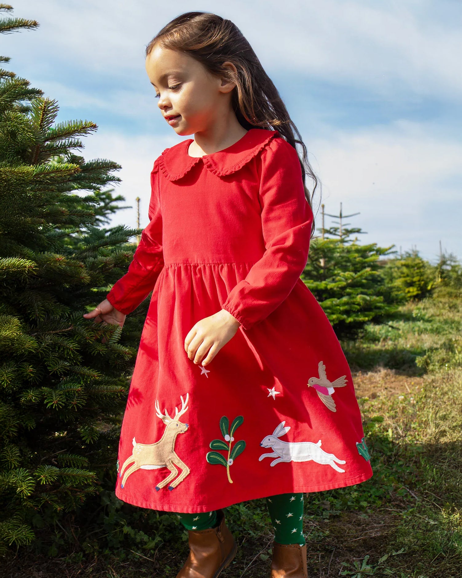 Child wearing Frugi Peony Corduroy Dress Red Robin - a Christmas party dress made from GOTS organic cotton - available at Babipur.
