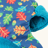 Frugi kids navy playtime trapper hat laid flat showing the repeating leaf and acorn design and aqua fleece inner lining.