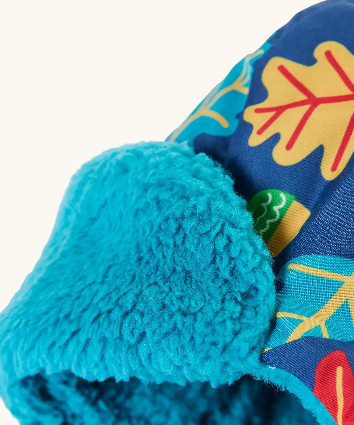 Frugi kids navy playtime trapper hat showing close up of the aqua fleece inner liner on the front flap