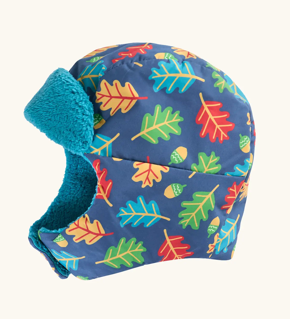 Frugi kids navy playtime trapper hat with a repeating leaf and acorn design and aqua fleece inner lining.