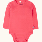 Frugi baby GOTS organic cotton pointelle body in rhubarb pink. features popper fasteners on the shoulder and gusset for easy dressing