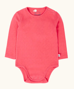 Frugi baby GOTS organic cotton pointelle body in rhubarb pink. features popper fasteners on the shoulder and gusset for easy dressing