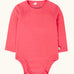 Frugi baby GOTS organic cotton pointelle body in rhubarb pink. features popper fasteners on the shoulder and gusset for easy dressing