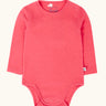 Frugi baby GOTS organic cotton pointelle body in rhubarb pink. features popper fasteners on the shoulder and gusset for easy dressing
