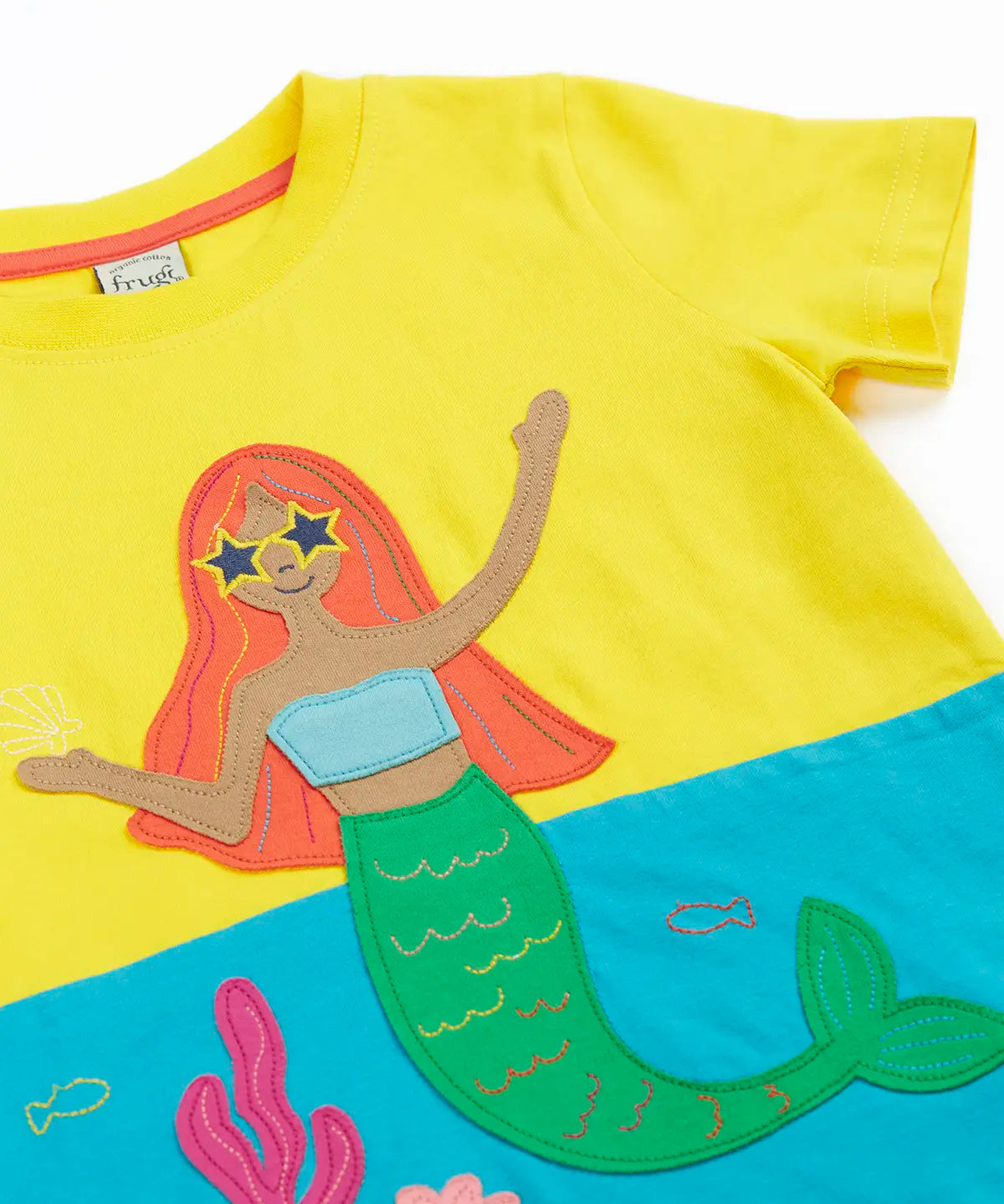 Frugi Poldhu hotchpotch short sleeve t-shirt laid flat in yellow and aqua with a mermaid patch on the front