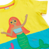 Frugi Poldhu hotchpotch short sleeve t-shirt laid flat in yellow and aqua with a mermaid patch on the front
