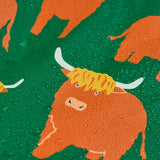 Frugi waterproof puddle buster coat in highland grazing showing the repeating highland cow design and water beading