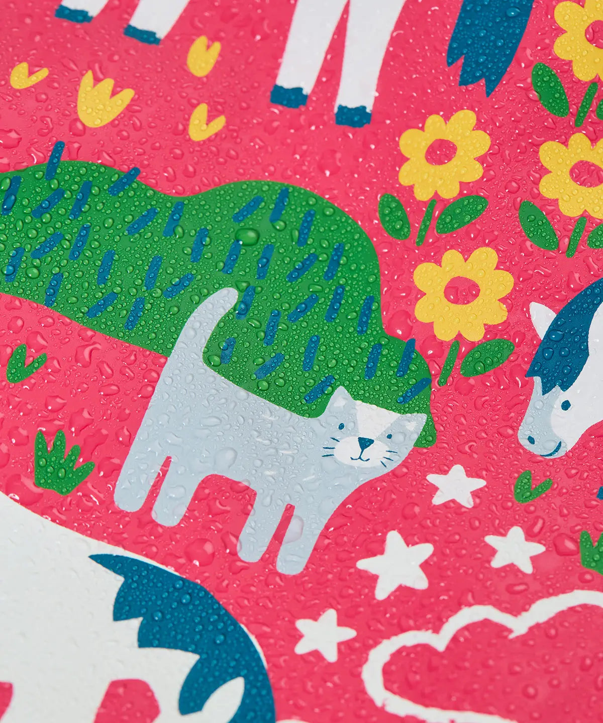 Frugi waterproof puddle buster coat in purrfect ponies showing the repeating cat and pony design and water beading