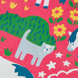 Frugi waterproof puddle buster coat in purrfect ponies showing the repeating cat and pony design and water beading