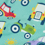 Frugi waterproof puddle buster coat in terrific tractors showing a close up of the repeating tractor design and water beading
