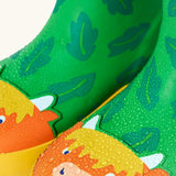 Frugi natural rubber, waterproof puddle buster wellingtons in palm/highland cow design showing water beading 